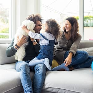 happy family sitting together on couch